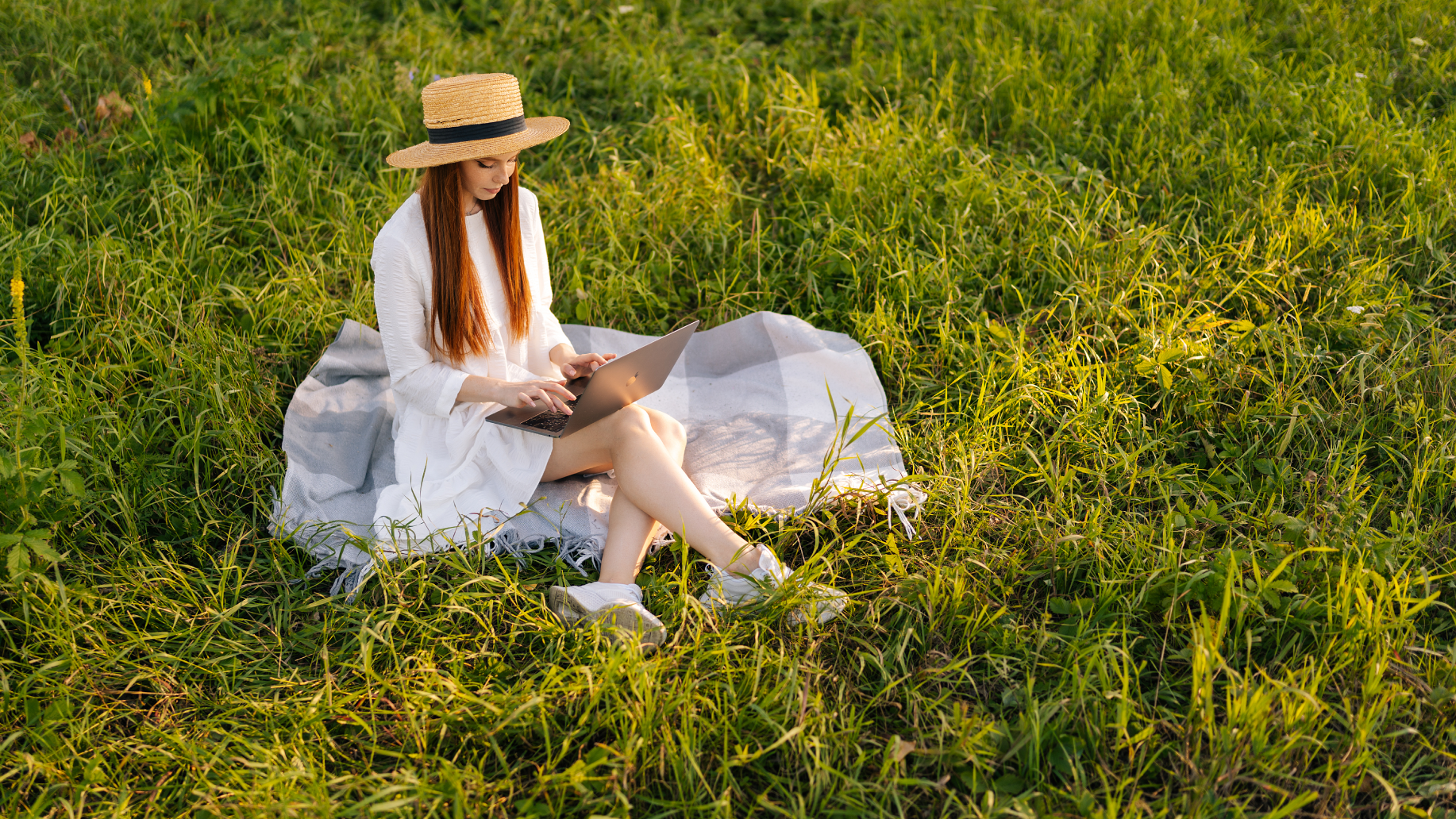 Young woman telelworking in a field