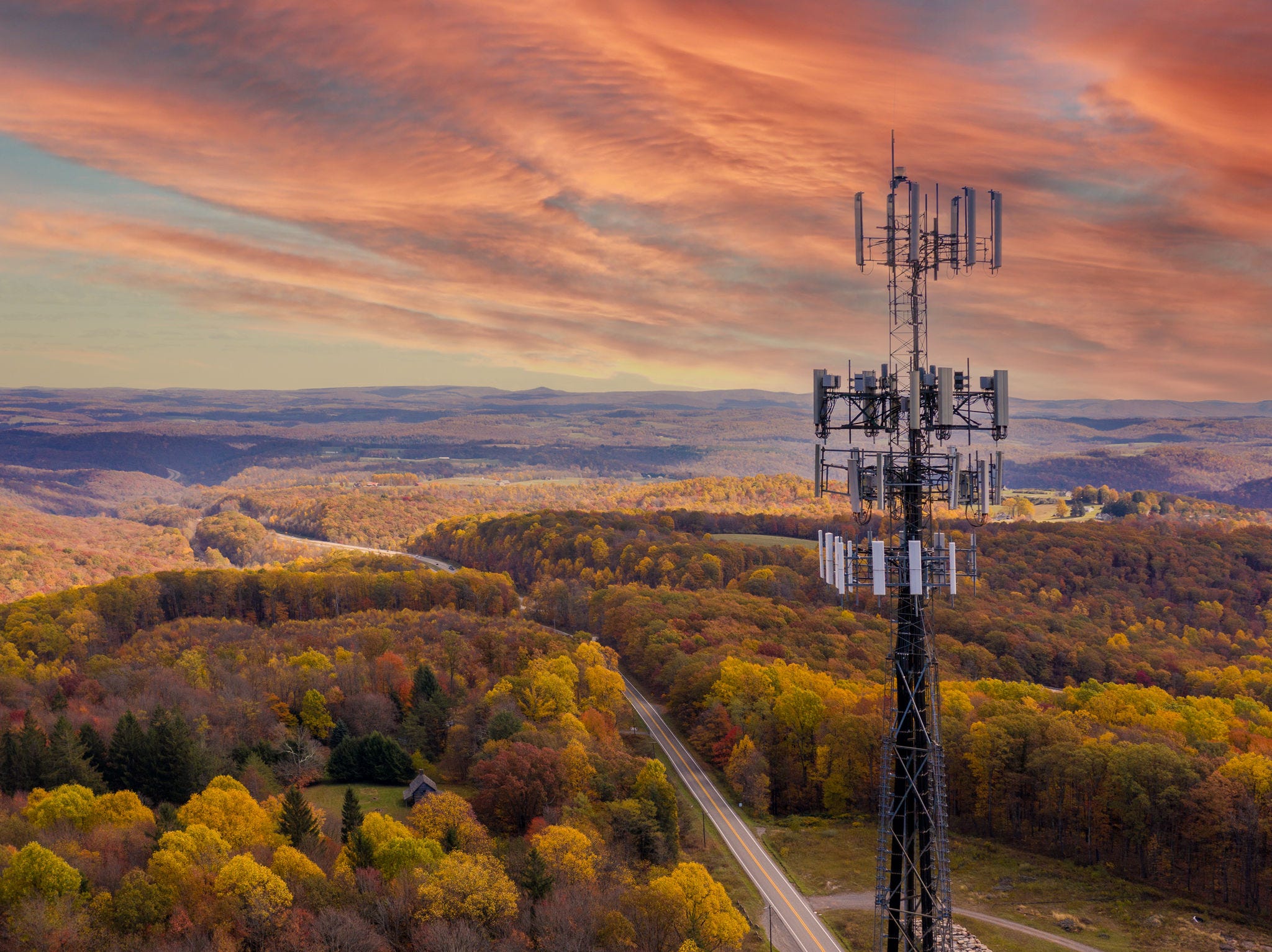 Aerial view of mobile phone cell tower over forested rural area of West Virginia to illustrate lack of broadband internet service; Shutterstock ID 1913449774; NP: OECD.org