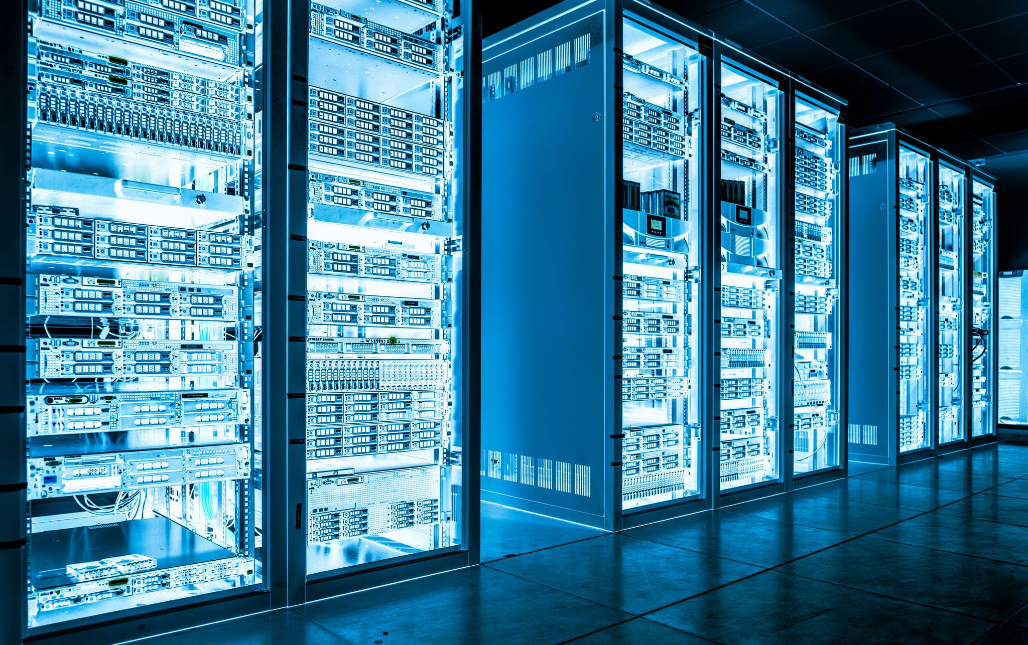 Big data dark server room with bright blue equipment; Shutterstock ID 571378933; NP: OECD.org