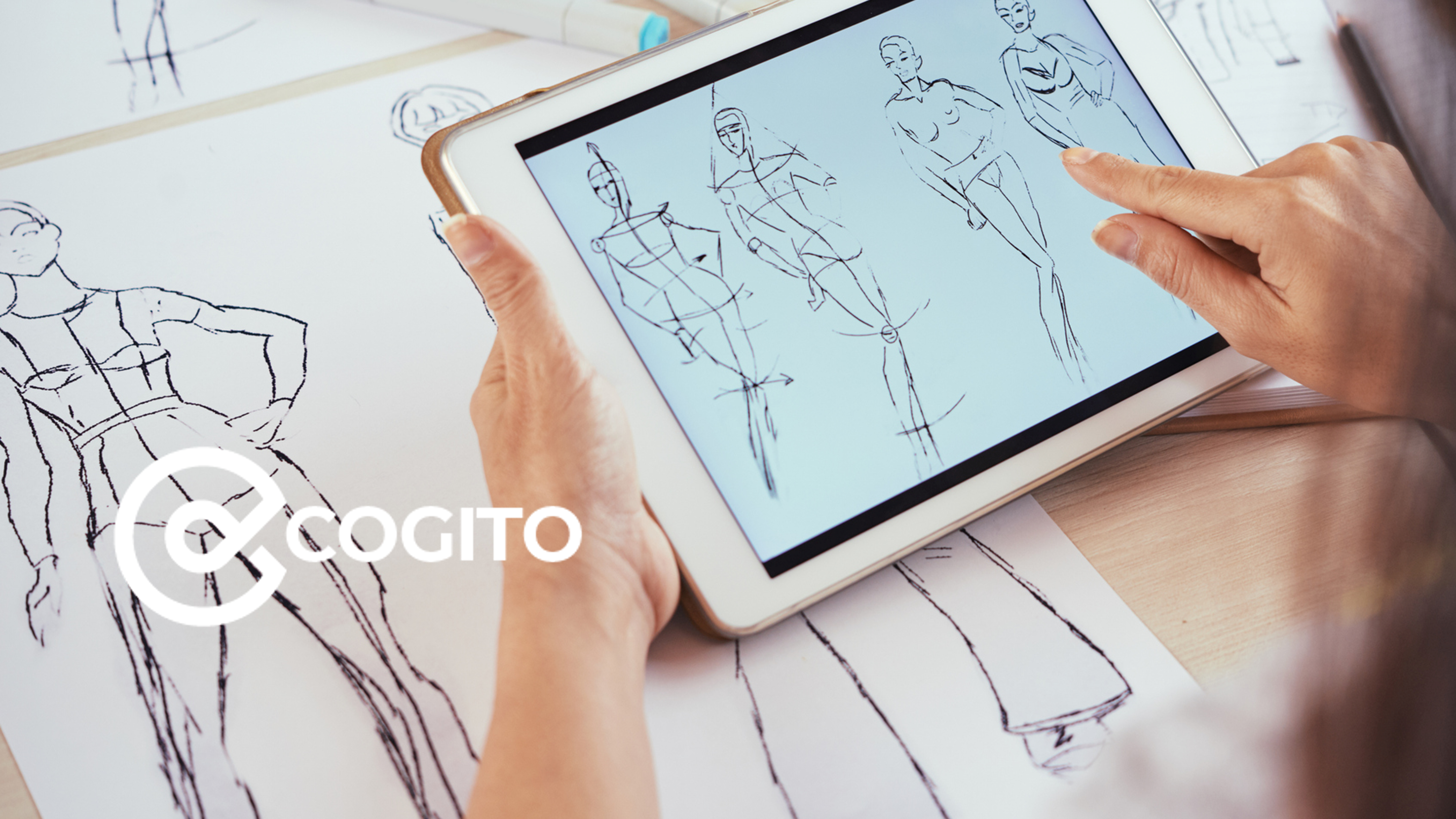 girl looking at fashion sketches on tablet