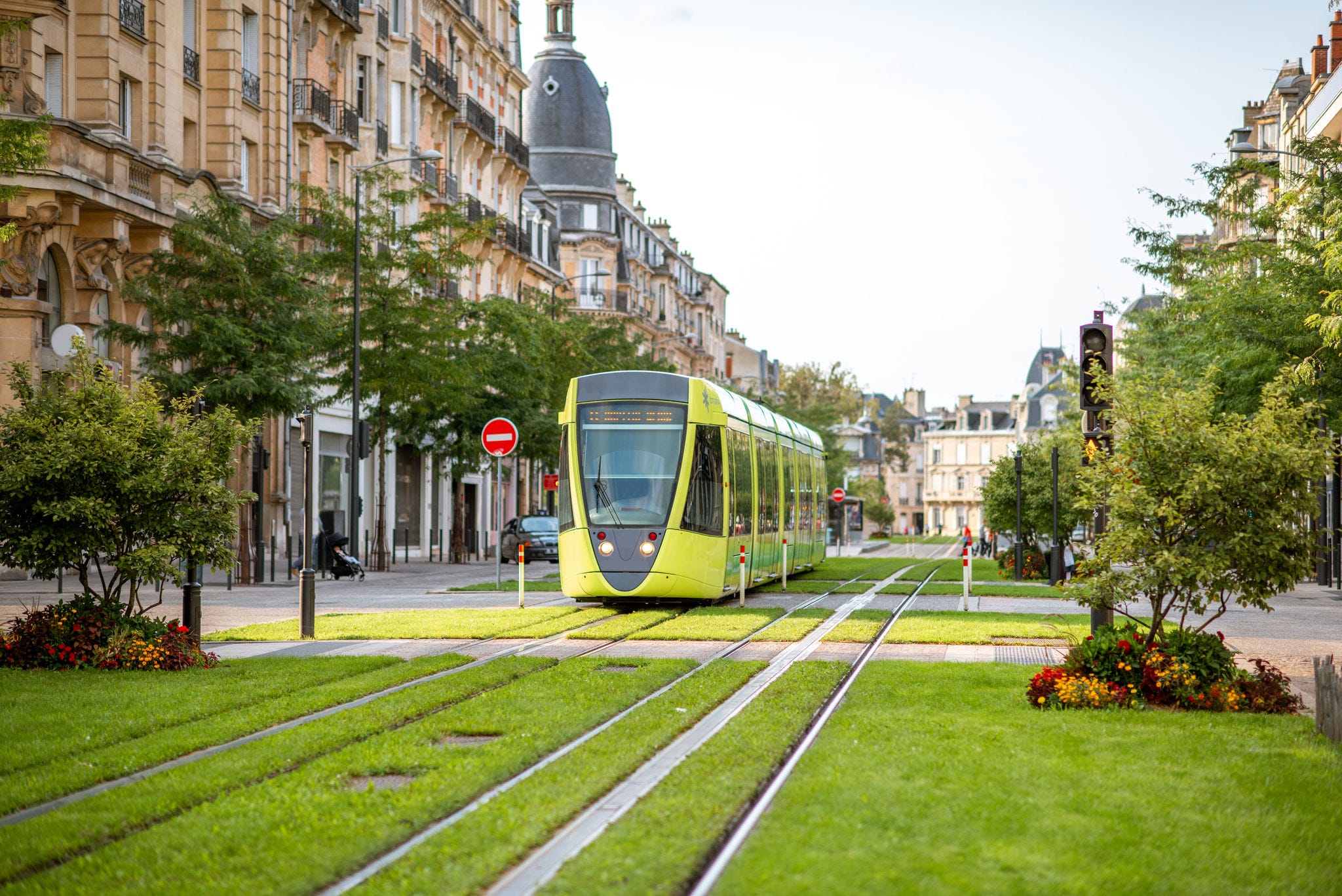 Street view with green railway of public transport in Reims city in Champagne-Ardenne region of France