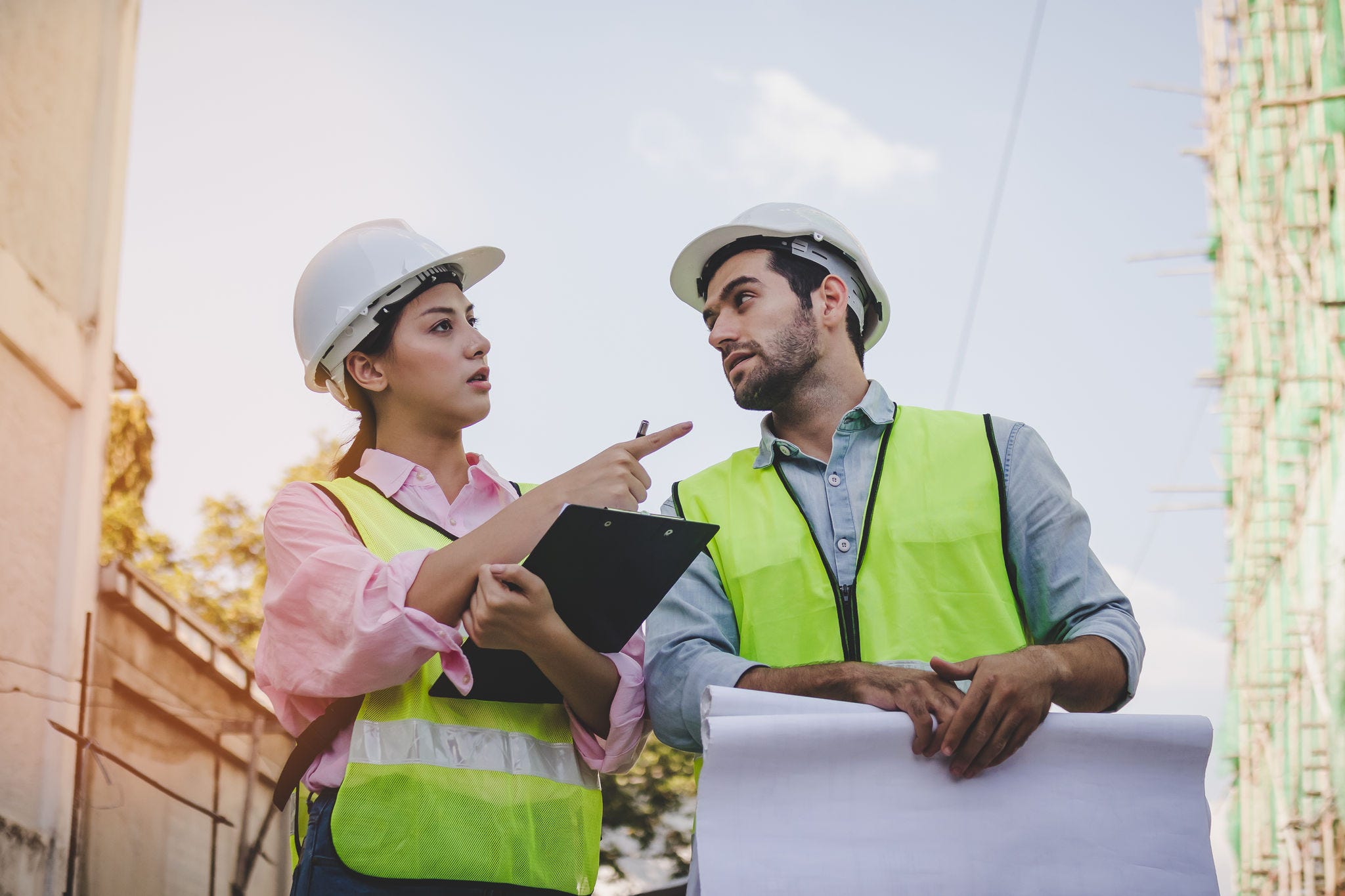 Team of young caucasian,asian man and woman contractor,partner explain and inspecting the reconstructed construction and renovated, holding the blueprint of apartment, home,house at job site, outdoor.; Shutterstock ID 1907888713; NP: Education Policy Outlook