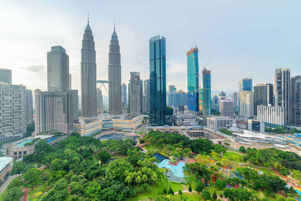 Awesome Kuala Lumpur skyline. Aerial view of a green city park in Kuala Lumpur, Malaysia. Skyscrapers are visible on blue sky background. Kuala Lumpur is a popular tourist destination of Asia.; Shutterstock ID 2436412835; NP: ECO