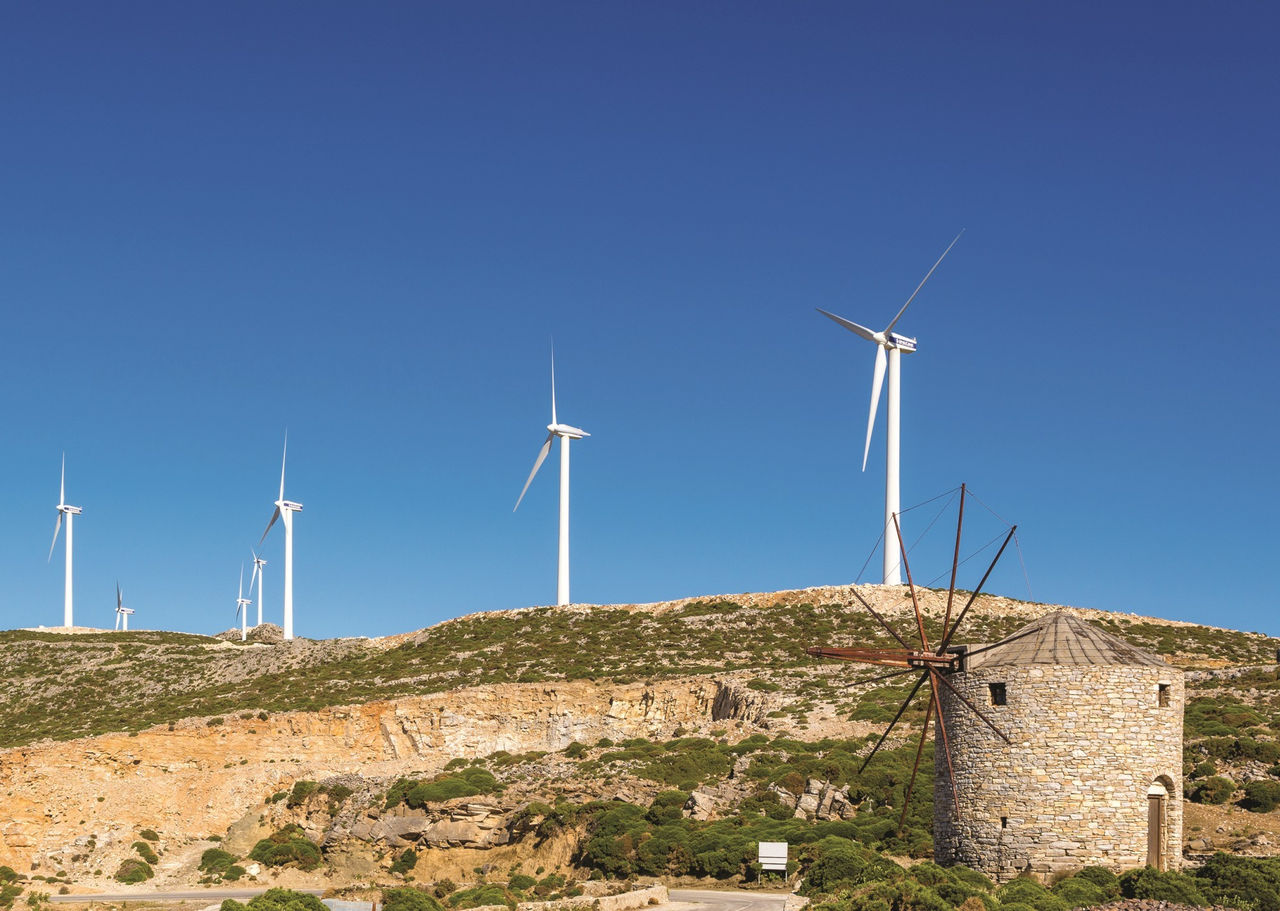 Wind farm and old windmill near Koronos village on Naxos island. Greece